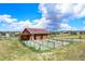 Exterior shot of charming barn with fenced area, ideal for livestock and rural living at 10325 Cherrywood Dr, Parker, CO 80138