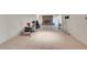 Large basement area with white walls and tile flooring, featuring a brick fireplace at 10325 Cherrywood Dr, Parker, CO 80138