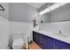 Bathroom with double sinks, large mirror, modern vanity with hardware and white wainscoting at 10325 Cherrywood Dr, Parker, CO 80138