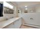Well-lit bathroom with tile floor, a large mirror, and a vanity with white cabinets at 10325 Cherrywood Dr, Parker, CO 80138