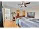 Bright bedroom with hardwood flooring, ceiling fan, and ensuite bathroom view at 10325 Cherrywood Dr, Parker, CO 80138
