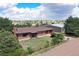 Aerial shot showcasing the property's brick home and barn under a cloudy sky at 10325 Cherrywood Dr, Parker, CO 80138