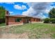 Charming brick ranch-style home features mature trees and landscaping at 10325 Cherrywood Dr, Parker, CO 80138