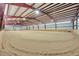 Spacious indoor arena featuring sand, sturdy metal beams, and bright overhead lighting at 10325 Cherrywood Dr, Parker, CO 80138