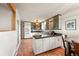 Bright kitchen features white cabinets, black countertops, stainless appliances, and tile floors at 10325 Cherrywood Dr, Parker, CO 80138