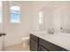 Modern bathroom featuring a white countertop, white toilet and bright window at 13826 Honey Hush Trl, Parker, CO 80134