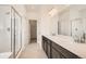 Bright bathroom with dual sinks, white countertop, and glass-enclosed shower at 13826 Honey Hush Trl, Parker, CO 80134