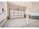 Spacious garage with a white paneled door and sealed concrete flooring at 13826 Honey Hush Trl, Parker, CO 80134
