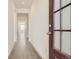 Bright hallway with wood floors, neutral walls, and natural light streaming through the entrance door at 13826 Honey Hush Trl, Parker, CO 80134