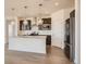 Kitchen features wood floors, stainless steel appliances, granite countertops, and dark cabinetry at 13826 Honey Hush Trl, Parker, CO 80134