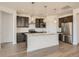 Kitchen features wood floors, stainless steel appliances, granite countertops, and dark cabinetry at 13826 Honey Hush Trl, Parker, CO 80134