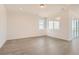 Bright living room featuring wood floors, neutral walls, and large windows with a view at 13826 Honey Hush Trl, Parker, CO 80134