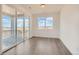Bright room featuring wood floors, neutral walls, and sliding doors that lead to an outdoor view at 13826 Honey Hush Trl, Parker, CO 80134