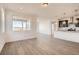 Open-concept living room featuring wood floors, neutral walls, and adjacent to the kitchen at 13826 Honey Hush Trl, Parker, CO 80134
