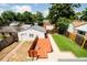 Backyard with deck, patio, artificial turf, landscaping, and detached garage at 3519 Newton St, Denver, CO 80211
