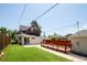 Expansive backyard with a deck, patio, grassy area, and privacy fence offers ample space at 3519 Newton St, Denver, CO 80211
