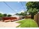 Spacious backyard with a wooden deck, manicured lawn, and privacy fence perfect for outdoor enjoyment at 3519 Newton St, Denver, CO 80211