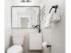 Modern bathroom features a sleek mirror, fixtures, toilet, and towel rack at 3519 Newton St, Denver, CO 80211