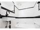 Modern bathroom with white subway tile, black accents, and sleek fixtures at 3519 Newton St, Denver, CO 80211