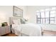 Serene bedroom with a large window, hardwood floors, and a comfortable bed at 3519 Newton St, Denver, CO 80211