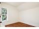 Bright bedroom features gleaming hardwood floors and a large window allowing for ample natural light at 3519 Newton St, Denver, CO 80211