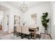 Elegant dining room with modern lighting, stylish rug, and a view to an adjacent room at 3519 Newton St, Denver, CO 80211