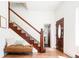Welcoming entryway with wood staircase, a bench seat, and front door at 3519 Newton St, Denver, CO 80211