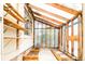Sunny greenhouse featuring wooden frames, shelving, and planting beds at 3519 Newton St, Denver, CO 80211