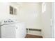 Well-lit laundry room features a washer and dryer, storage, and a convenient bench at 3519 Newton St, Denver, CO 80211