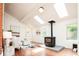 Spacious living room with fireplace, skylights, hardwood floors, and comfortable seating at 3519 Newton St, Denver, CO 80211