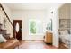 Inviting living room with hardwood floors, staircase, and a view of the outdoors through a bright window at 3519 Newton St, Denver, CO 80211