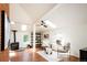 Sunlit living room with skylights, hardwood floors, fireplace, and comfortable seating at 3519 Newton St, Denver, CO 80211