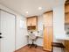 Bright office space with built-in desk, cabinets, and natural light from a window at 3519 Newton St, Denver, CO 80211