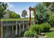Backyard fence and garden view with a lush grassy area and mature trees at 8427 Chase Dr, Arvada, CO 80003