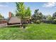 Expansive backyard featuring a well-manicured lawn and charming patio area at 8427 Chase Dr, Arvada, CO 80003