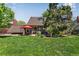 Lush backyard with patio and mature trees, perfect for outdoor entertaining at 8427 Chase Dr, Arvada, CO 80003