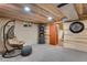 Finished basement featuring carpet, and sitting area with hanging chair and unique wood plank ceiling at 8427 Chase Dr, Arvada, CO 80003