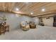 Spacious finished basement featuring neutral walls, carpet, and sitting area with comfortable armchairs at 8427 Chase Dr, Arvada, CO 80003