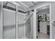 Bathroom with a clear glass shower and a built-in closet with ample storage space at 8427 Chase Dr, Arvada, CO 80003
