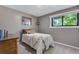 Cozy bedroom with a comfortable bed, natural light from the window, and soothing gray walls at 8427 Chase Dr, Arvada, CO 80003