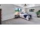 Spacious bedroom with a decorative ceiling fan, a comfortable bed, and carpet flooring at 8427 Chase Dr, Arvada, CO 80003