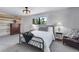 Well-decorated bedroom featuring a cozy bed, wood accent wall, carpet flooring, and ample natural light at 8427 Chase Dr, Arvada, CO 80003