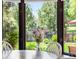 Sunlit breakfast nook with window views of the lush backyard at 8427 Chase Dr, Arvada, CO 80003