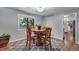 Cozy dining area with a round table, chairs, natural light and hardwood floors at 8427 Chase Dr, Arvada, CO 80003