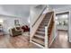 Welcoming entryway featuring hardwood floors, staircase, and views into the living spaces at 8427 Chase Dr, Arvada, CO 80003