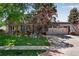 Inviting home exterior with an attached garage and a well-kept front lawn and landscaping at 8427 Chase Dr, Arvada, CO 80003