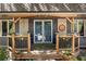 Inviting covered front porch with a seating area, plants, and attractive exterior details at 8427 Chase Dr, Arvada, CO 80003
