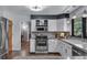 Well-equipped kitchen with stainless steel appliances, granite countertops, and open layout at 8427 Chase Dr, Arvada, CO 80003