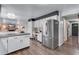 Spacious kitchen features stainless steel appliances, modern cabinetry, and hardwood floors at 8427 Chase Dr, Arvada, CO 80003