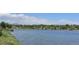 Scenic lake view surrounded by lush green trees and mountains in the distance at 8427 Chase Dr, Arvada, CO 80003
